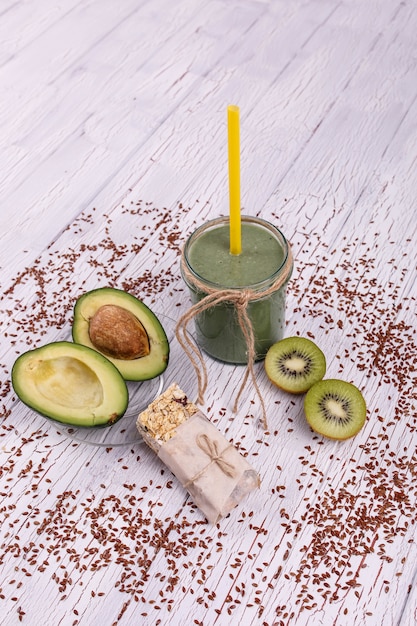 Free Photo healthy green smoothie with avocado and kiwi lie on the table