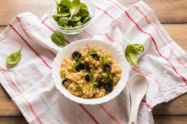 Free Photo healthy homemade oatmeal for breakfast on napkin over wooden table