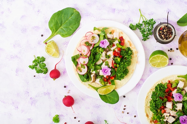 Free Photo healthy mexican corn tacos with boiled chicken breast, spinach, radish and paprika