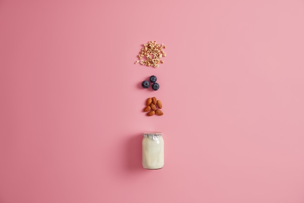 Free Photo healthy nutrition, clean eating concept. ingredients for oatmeal with blueberry, almond nut and yoghurt. preparing yummy sweet nutrient low calorie dessert. breakfast time. muesli with fruits.