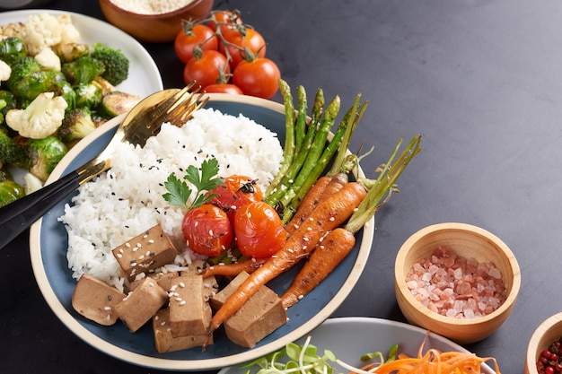 Free photo healthy organic tofu and rice buddha bowl with veggies.