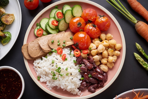 Free photo healthy organic tofu and rice buddha bowl with veggies.