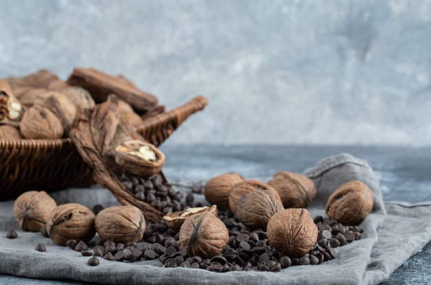 Free photo healthy walnuts with aroma coffee beans on a gray tablecloth.