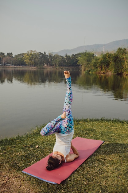 Free photo healthy woman doing yoga in the nature