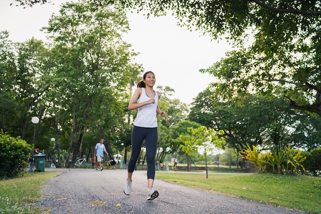 Free photo healthy young asian runner woman in sports clothing running and jogging on sidewalk