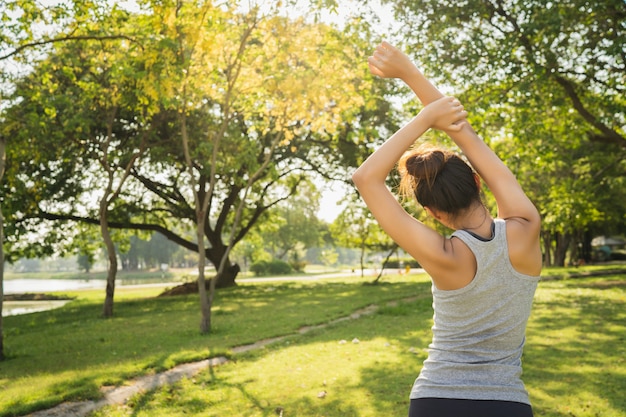 Healthy young Asian runner woman warm up the body stretching before exercise and yoga 