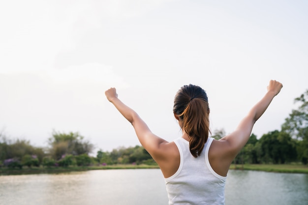 Healthy young Asian runner woman warm up the body stretching before exercise and yoga