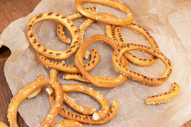 Heap of bagels with sesame seeds on wooden background