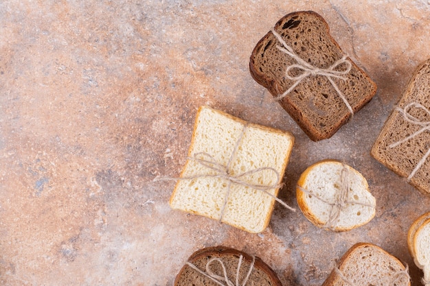 Heap of various bread, on the marble table.