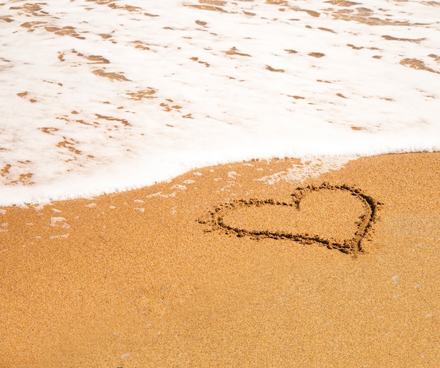 Free photo heart on the beach.