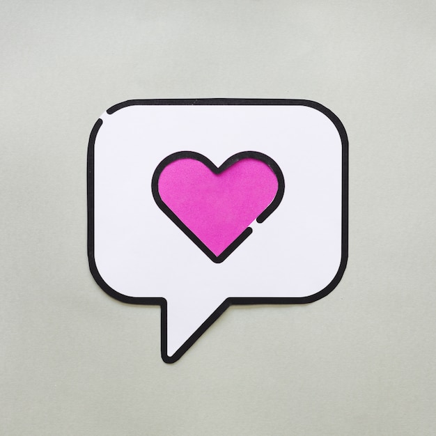 Heart in bubble speech icon on grey table