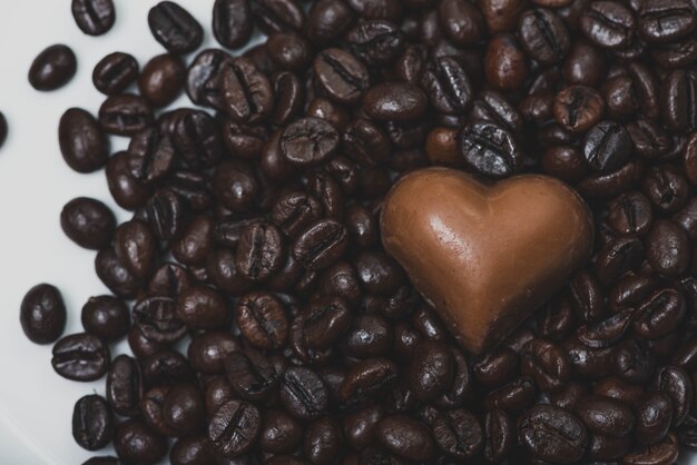 Heart of chocolate on coffee beans