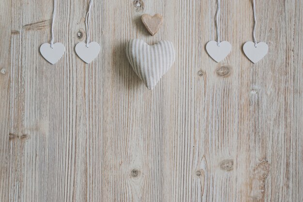 Heart of fabric, brown heart and hearts hanging on ropes