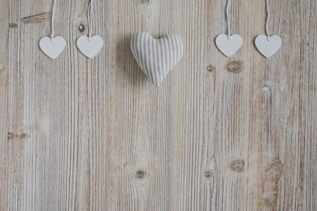 Heart of fabric and hearts hanging on ropes