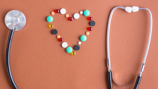 Free photo heart from pills near resonator and ear plugs of stethoscope