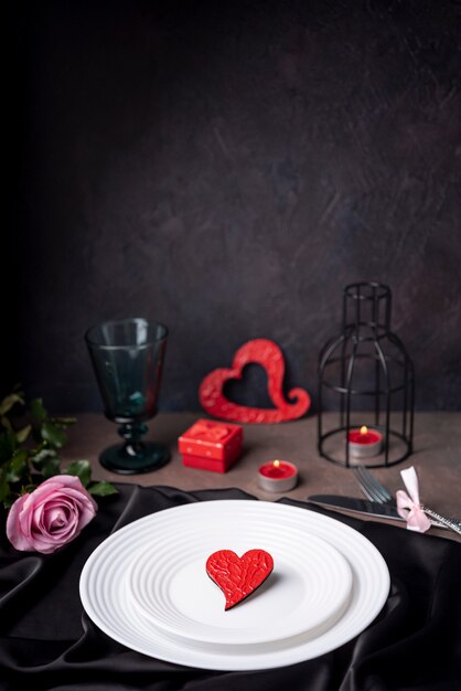 Heart on plates with rose and candles