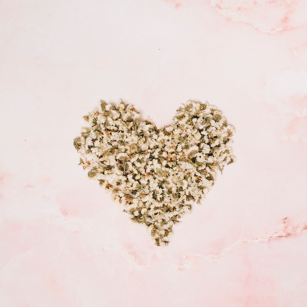 Heart shape from small flowers on table 