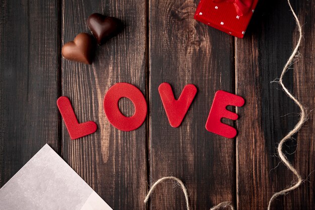 Heart-shaped chocolates on wooden background with love