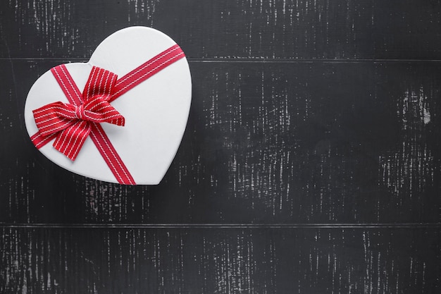 Free photo heart-shaped gift box on black background