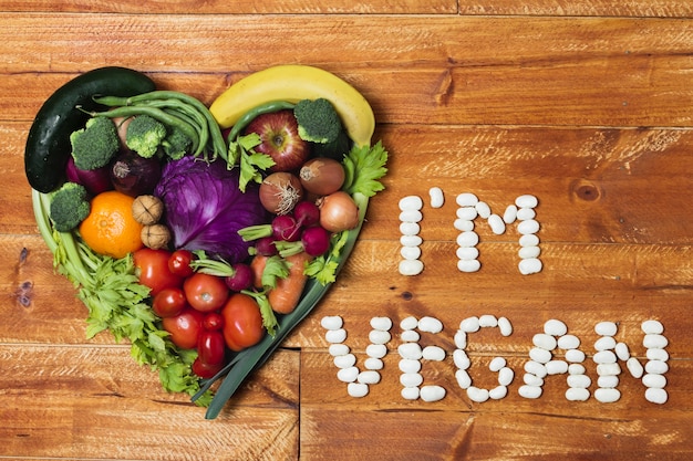 Heart shaped vegetable arrangement on wooden background