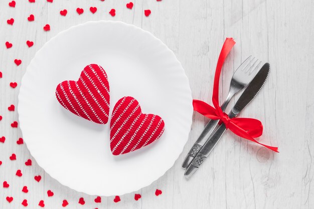 Hearts on plate near cutlery