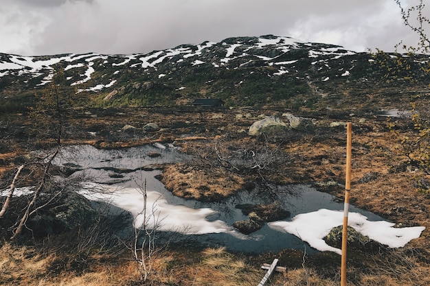 Heavy clouds hang over the mountains covered with snow