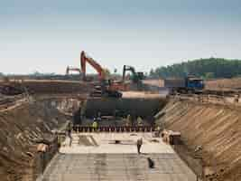 Free photo heavy machines and construction workers working on a building