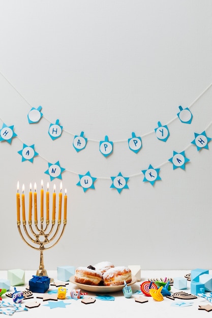 Free Photo hebrew menorah with sweets on a table