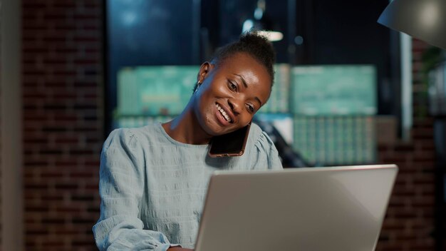 Hedge fund trader talking on phone call about forex trade profit, helping with business and economy growth. Doing remote communication about stock market exchange on laptop computer.