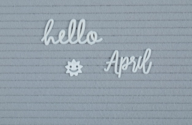 Free photo hello april poster on grey surface