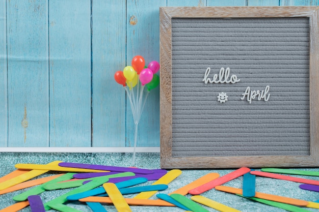 Free Photo hello april poster on grey surface