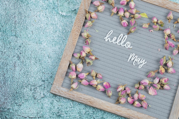 Hello may poster embedded on grey background with flower blossoms around