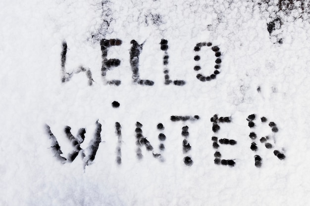 Free Photo hello winter text written on snow