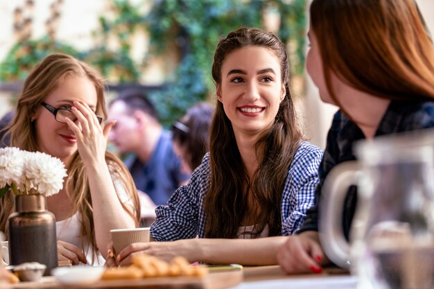 Henparty with best friends and yummy snacks at the cozy open air cafe  at warm summer day