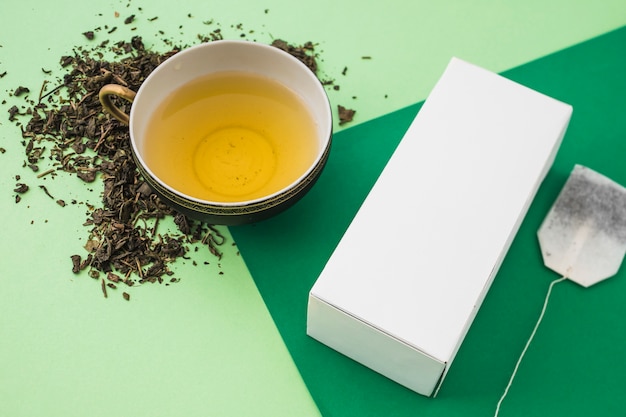 Herb box with tea cup on light and dark background