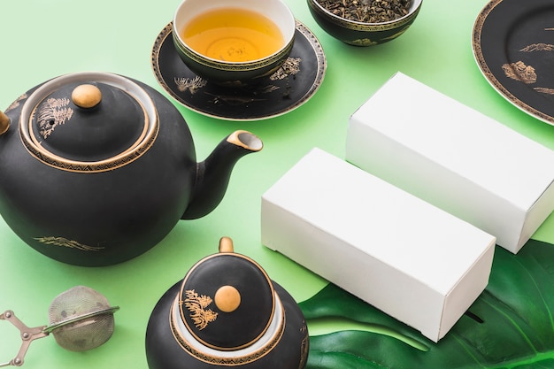 Herbal tea set with two white boxes on green backdrop