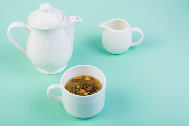 Free Photo herbal tea with crockery on turquoise background