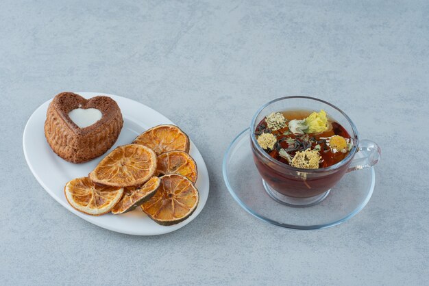 Herbal tea with dried orange on white background. High quality photo