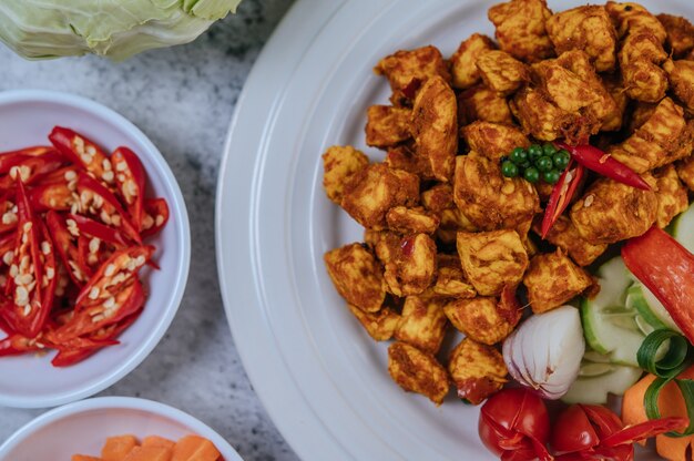 Herbs Fried chicken with Chili, Tomato, Cucumber, Carrot, and Fresh pepper.