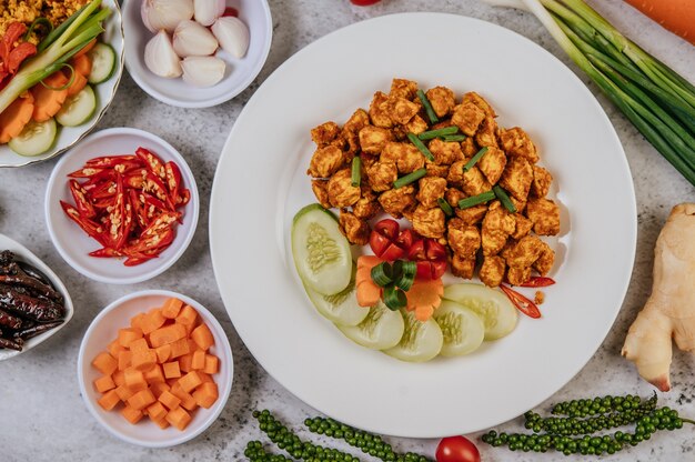 Herbs Fried chicken with Chili, Tomato, Cucumber, Carrot, and Fresh pepper.