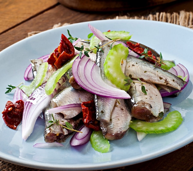 Herring salad with sun-dried tomatoes, celery and red onion