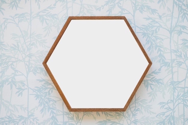 Free photo hexagon white frame on wallpaper