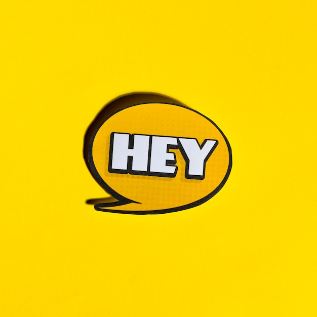 Hey speech bubble on yellow backdrop