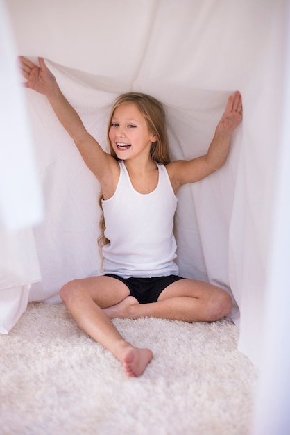 Free photo hiding in her house made of duvet