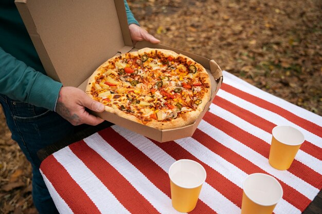 High angle adult holding pizza