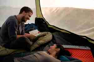 Free photo high angle adventurous couple bivouacking