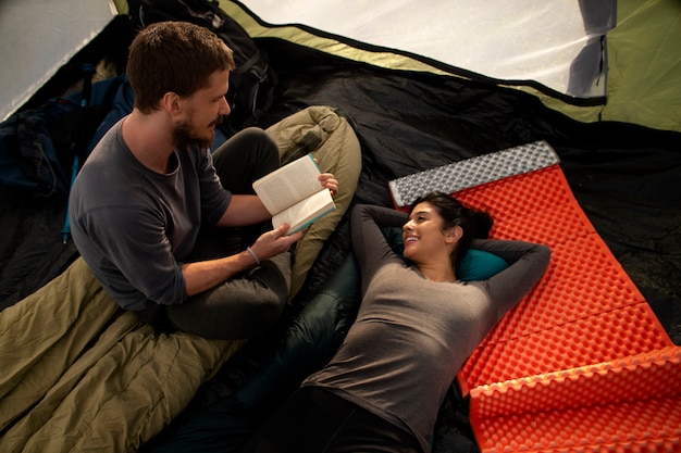 Free photo high angle adventurous couple bivouacking