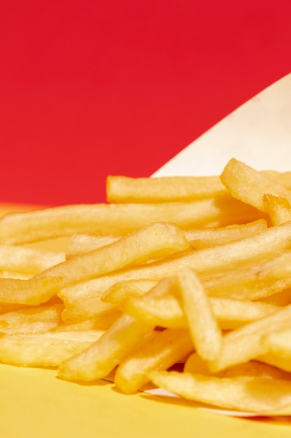 Free Photo high angle arrangement with fries and red background