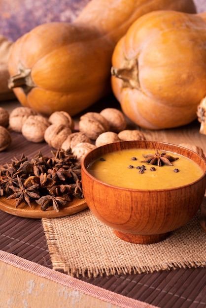 High angle arrangement with pumpkin soup and nuts