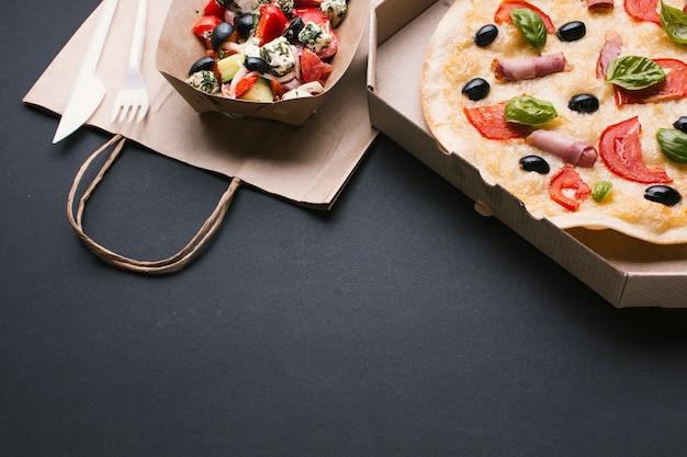 Free photo high angle arrangement with salad and pizza